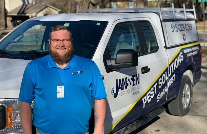 Janssen Pest Technician standing in front of a truck