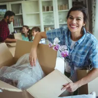 woman unpacking in new home with family
