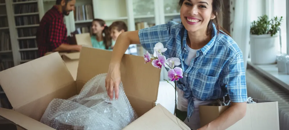 woman unpacking in new home with family
