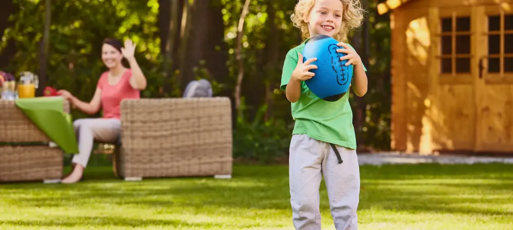 kid outside with ball