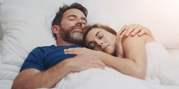 couple sleeping peacefully in bed