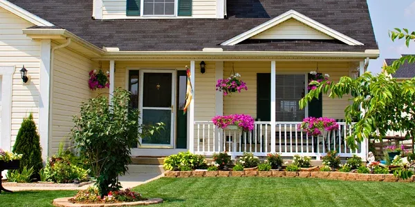 house with front porch and hanging flower baskets